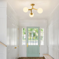 Gold frosted glass globe semi-flush ceiling light in bright entryway