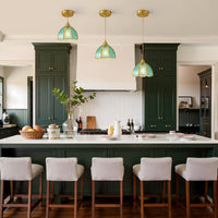 Three blue water ripple glass pendant lights displayed above a kitchen island