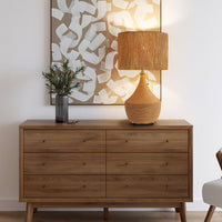 Boho rattan table lamp with woven paper rope shade displayed on a wooden dresser