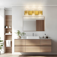 Brushed Gold clear wavy crystal LED wall sconce installed above a bathroom vanity mirror