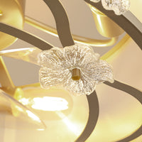 Close-up of clear textured glass flower accents on gold-tone ceiling fan frame