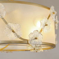 Close-up of linen shade and clear glass flower details on floral ceiling fan