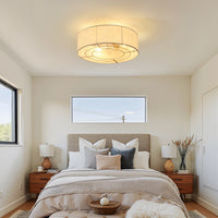 Gold linen-blend flush mount ceiling fan with light installed in a modern bedroom