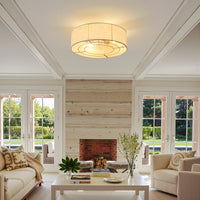 Gold linen-blend flush mount ceiling fan with light installed in a bright living room