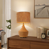 Boho rattan table lamp with paper rope drum shade styled on a wooden console table