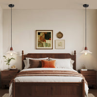 Pair of clear ribbed glass pendant lights with wood accents hanging beside a bedroom bed