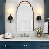 Black linen shade wall sconces set of 2 beside an arched mirror